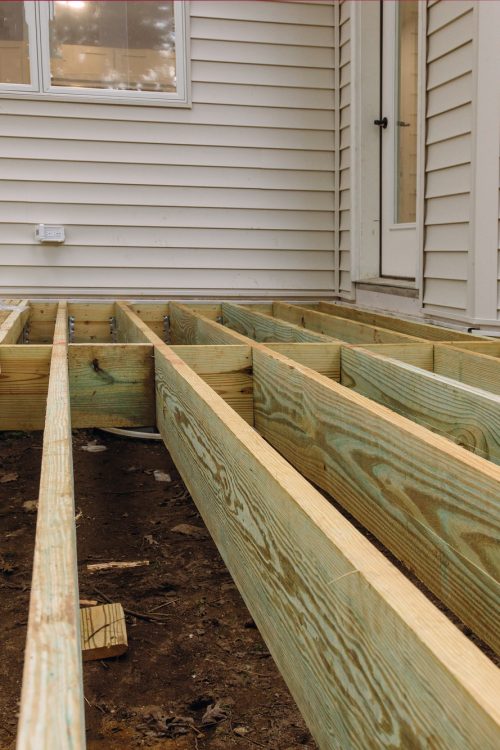 Installing deck patio construction. boards with above ground deck Installing deck patio construction. boards with above ground deck