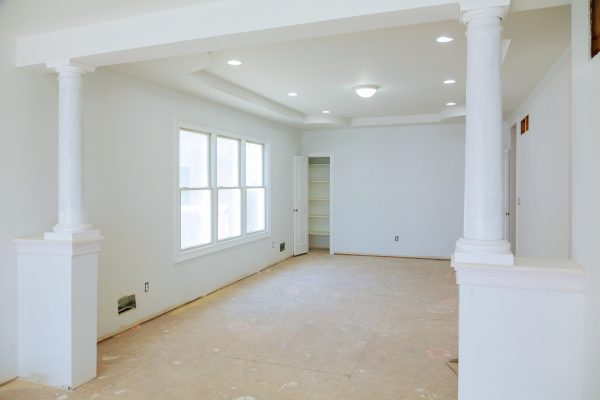 White interior with big blank wall new home construction interior drywall and finish details White interior with big blank wall new home construction interior drywall and finish details